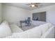 Comfortable living room features a large television, desk, and plush sectional sofa at 10279 Fragrant Apple Ct, Las Vegas, NV 89141