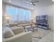 Sun-filled living room with comfortable seating, a sleek entertainment center, and contemporary decor at 10279 Fragrant Apple Ct, Las Vegas, NV 89141