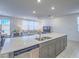 Open-concept kitchen and living area with a large island, modern appliances, and comfortable seating at 10279 Fragrant Apple Ct, Las Vegas, NV 89141