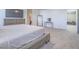 Neutral main bedroom featuring a seating bench and large TV at 10279 Fragrant Apple Ct, Las Vegas, NV 89141