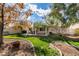 Backyard with covered patio, grassy area, landscaping, and mature trees at 1114 Cedar Dove Rd, North Las Vegas, NV 89081