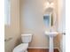 Charming half-bath featuring a pedestal sink, updated fixture and tiled flooring for added style at 1152 Gecko Rd, Henderson, NV 89002