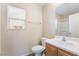 Bright bathroom with a single sink vanity, toilet, and a window providing natural light at 1152 Gecko Rd, Henderson, NV 89002