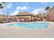 Community pool featuring a gated fence, lounge chairs and mountainous views at 1152 Gecko Rd, Henderson, NV 89002