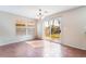Cozy dining area featuring tile flooring, a modern chandelier, and sliding door access to the backyard at 1152 Gecko Rd, Henderson, NV 89002
