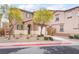 Inviting townhouse showcasing a well-manicured front yard with vibrant greenery and charming curb appeal at 1152 Gecko Rd, Henderson, NV 89002