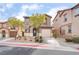 Inviting two-story home featuring a private garage, tidy landscaping, and a welcoming front entrance at 1152 Gecko Rd, Henderson, NV 89002