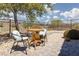 Backyard patio featuring a table and chairs with landscaping and desert views at 1407 Wheelwright Ct, Mesquite, NV 89034