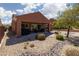 Desert landscaped backyard with a covered patio and desert views at 1407 Wheelwright Ct, Mesquite, NV 89034