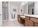 Bright bathroom with walk-in shower, safety tub, and double sink vanity featuring wood cabinetry at 1407 Wheelwright Ct, Mesquite, NV 89034