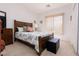 Comfortable bedroom featuring a wood-framed bed, soft carpet, and a bright window at 1407 Wheelwright Ct, Mesquite, NV 89034