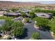 Aerial view of the community clubhouse with circular driveway and mature trees at 1407 Wheelwright Ct, Mesquite, NV 89034