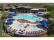 Community pool featuring hot tubs, lounge chairs, umbrellas and desert landscape at 1407 Wheelwright Ct, Mesquite, NV 89034