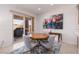 Cozy dining area with a view of the backyard and a colorful piece of artwork at 1407 Wheelwright Ct, Mesquite, NV 89034