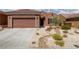 Beautiful single story home featuring low maintenance desert landscaping and a two-car garage at 1407 Wheelwright Ct, Mesquite, NV 89034