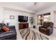 Inviting living room with a large TV, comfortable seating, and a colorful rug at 1407 Wheelwright Ct, Mesquite, NV 89034