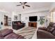 Bright living room featuring a large TV, comfortable seating, and plenty of natural light at 1407 Wheelwright Ct, Mesquite, NV 89034