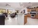 Open-concept living space featuring tile floors, natural light, and a modern kitchen at 1407 Wheelwright Ct, Mesquite, NV 89034