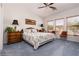 Comfortable bedroom with soft lighting, floral bedding, and natural light from multiple windows at 1407 Wheelwright Ct, Mesquite, NV 89034