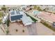 An aerial view of a single-story home with solar panels, driveway, artificial grass and inground pool at 1462 Rawhide St, Las Vegas, NV 89119