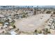 An aerial view of the community featuring houses near desert landscaping with a Las Vegas skyline backdrop at 1462 Rawhide St, Las Vegas, NV 89119