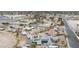 An aerial view of houses with pools near a school, surrounded by desert landscape and palm trees at 1462 Rawhide St, Las Vegas, NV 89119