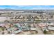 Aerial view of neighborhood, home, pools, and airport in background on a sunny day at 1462 Rawhide St, Las Vegas, NV 89119