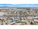 Aerial view of homes with pools, palm trees, and varied roof types near a major highway and airport at 1462 Rawhide St, Las Vegas, NV 89119