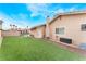 Backyard with artificial grass, block wall and view of the house at 1462 Rawhide St, Las Vegas, NV 89119