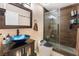 Modern bathroom featuring a beautiful vanity, glass shower with wood tile surround, and sleek toilet at 1462 Rawhide St, Las Vegas, NV 89119