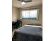 Cozy bedroom with a ceiling fan, desk and a window offering natural light at 1462 Rawhide St, Las Vegas, NV 89119