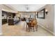 Bright dining area with tile floors, a wooden table set, and views into the adjacent kitchen at 1462 Rawhide St, Las Vegas, NV 89119