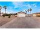 Spacious driveway leads to a well-maintained home with a white garage door and desert landscaping at 1462 Rawhide St, Las Vegas, NV 89119