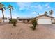 Inviting single-story home featuring desert landscaping, solar panels, and a quaint front entrance at 1462 Rawhide St, Las Vegas, NV 89119