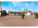 Attractive single-story home with gravel landscaping, a solar panel and an attached garage at 1462 Rawhide St, Las Vegas, NV 89119