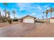 Beautiful front exterior featuring a long driveway with desert landscaping and attached two car garage at 1462 Rawhide St, Las Vegas, NV 89119