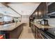 Kitchen with dark cabinets, granite countertops, stainless steel appliances, and center island with barstool seating at 1462 Rawhide St, Las Vegas, NV 89119