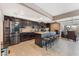 Eat-in kitchen features dark cabinets, stainless steel appliances, and an island with bar stool seating at 1462 Rawhide St, Las Vegas, NV 89119