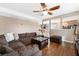 Open-concept living room with a comfortable brown sectional, hardwood floors, and ample natural light at 1462 Rawhide St, Las Vegas, NV 89119