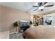 Spacious main bedroom featuring a ceiling fan, a mounted TV, and a walk-out to a room with an office space at 1462 Rawhide St, Las Vegas, NV 89119