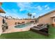 Relax in the backyard with a sparkling pool, sun loungers, and manicured lawn, perfect for outdoor entertaining at 1462 Rawhide St, Las Vegas, NV 89119
