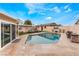 A backyard oasis boasts a sparkling pool, sun loungers, an outdoor tv and a patio area for relaxation at 1462 Rawhide St, Las Vegas, NV 89119