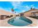 Backyard with a sparkling pool, outdoor seating, and lush landscaping creating a serene retreat at 1462 Rawhide St, Las Vegas, NV 89119