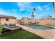 Backyard showcasing a pool, lounge chairs, and well-maintained landscaping with tall palm trees, creating a serene outdoor oasis at 1462 Rawhide St, Las Vegas, NV 89119