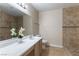 A bright bathroom features neutral tiling and a walk-in shower at 1560 Jamielinn Ln # 101, Las Vegas, NV 89110