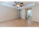 A cozy bedroom features neutral walls, a ceiling fan, and an attached bathroom at 1560 Jamielinn Ln # 101, Las Vegas, NV 89110