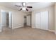 A cozy bedroom features neutral walls, a ceiling fan, and an attached bathroom at 1560 Jamielinn Ln # 101, Las Vegas, NV 89110