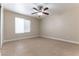 A cozy bedroom features neutral walls, a ceiling fan, and natural lighting at 1560 Jamielinn Ln # 101, Las Vegas, NV 89110