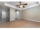 A cozy bedroom features neutral walls, a ceiling fan, and an attached bathroom at 1560 Jamielinn Ln # 101, Las Vegas, NV 89110