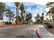 Welcoming entrance to Emerald Gardens featuring lush landscaping, gated entry, and community signage at 1560 Jamielinn Ln # 101, Las Vegas, NV 89110